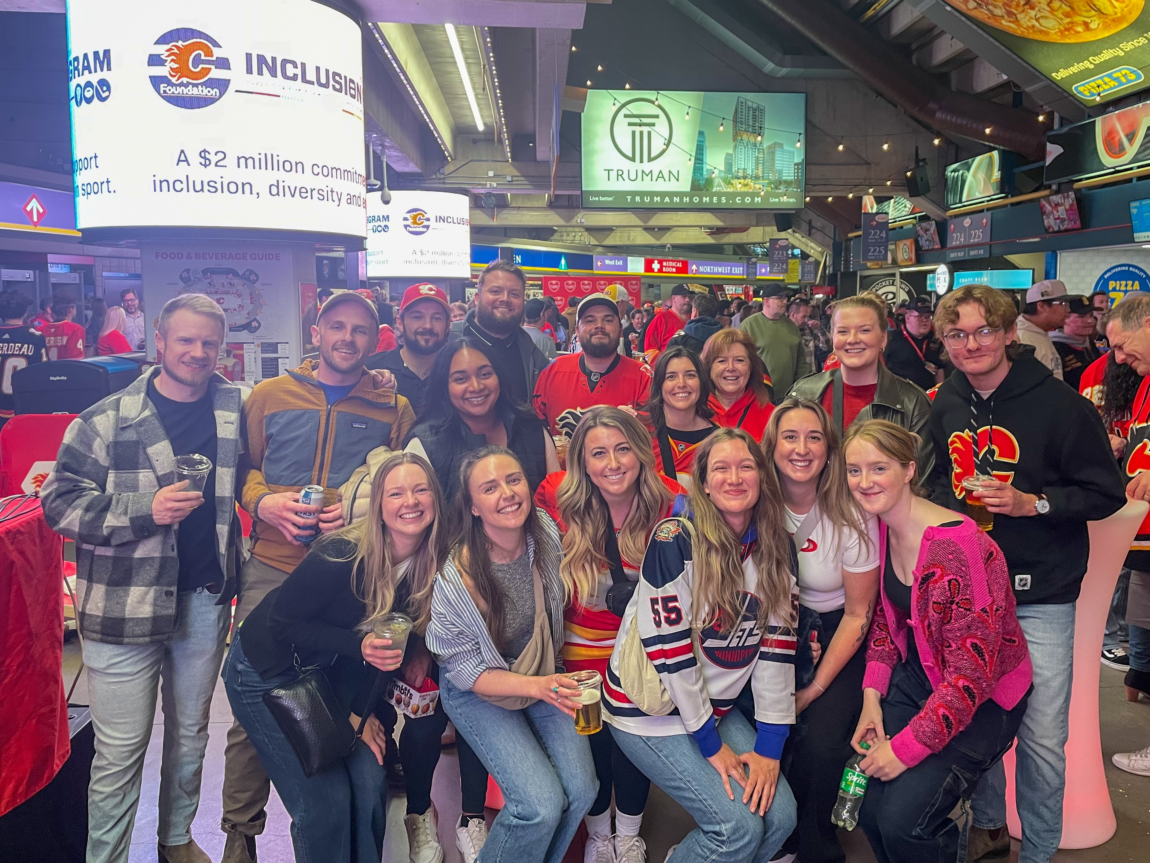 A group of people at a Calgary Flames hockey game
